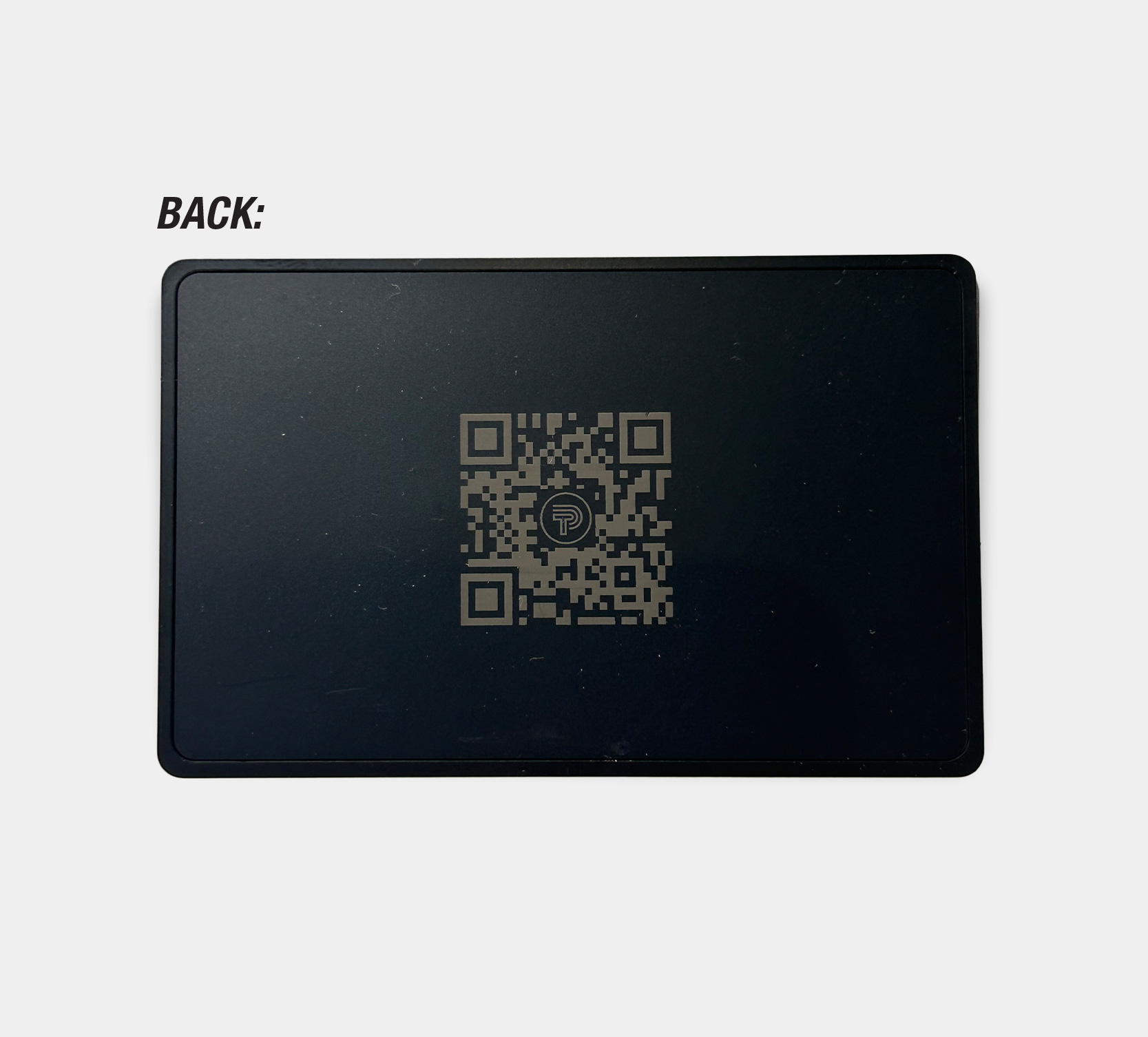 Image showing back of black metal NFC business card with QR Code laser engraved